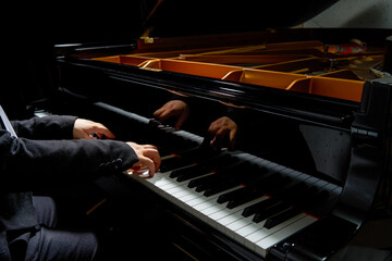 A pianist plays on the grand piano