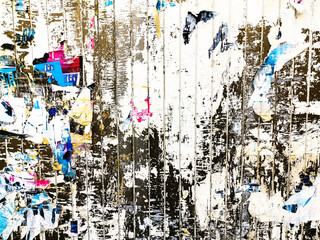 Layers of old colorful posters on wall damaged by time for your grunge style design
