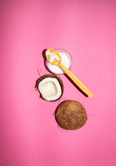 Obraz na płótnie Canvas Half of coconuts isolated on color background. Coconut cream. Top View. Flat lay.