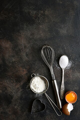 Culinary background with ingredients for baking : flour, egg and sugar. Top view with copy space.