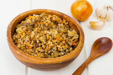 Boiled buckwheat porridge with stewed mushrooms and vegetables.
