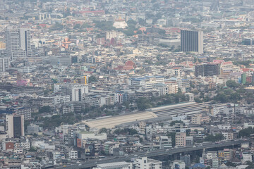 The view of Bangkok from the tallest building shows air pollution, dust, smoke. PM 2.5 Looking at the modern city mixed with temples, houses, old buildings and river.
