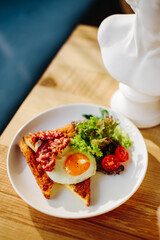 Breakfast with bacon, standing on the table, there is bacon in the plate