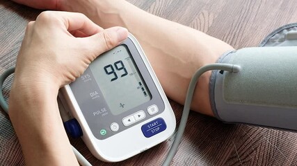 Woman check blood pressure monitor and heart rate monitor with digital pressure gauge. Health care and Medical concept