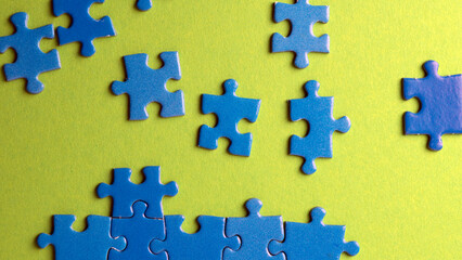 scattered puzzle pieces on colored background