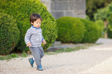 Fototapeta premium Portrait of a little eastern handsome baby boy playing outdoor in the park