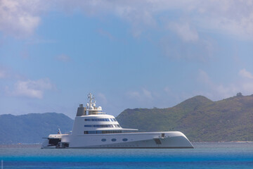 Obraz na płótnie Canvas Expensive stealth luxury super yacht moored off Curieuse island in the Seychelles