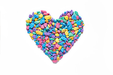 heart on a white background of small multi-colored sea pebbles, stone chips in the shape of a heart