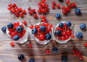 Naklejka na ściany i meble Natural yogurt with fresh berries and muesli. Healthy dessert. Top view.