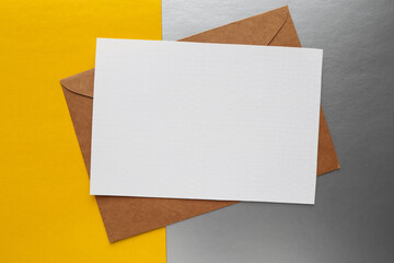Blank invitation greetings card on gray and yellow background 