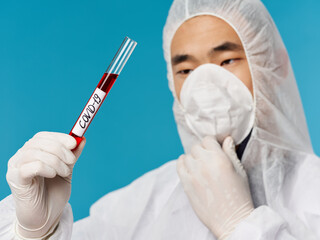 A man of Asian appearance holds a biotechnology research coronavirus blood test