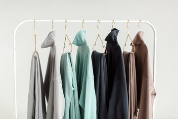 Obraz premium Stylish and comfortable clothes for teenagers hang on a hanger. Clothes for convenience on a white background