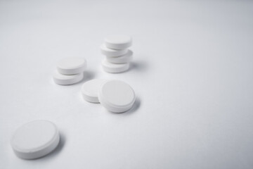 white pills on white background