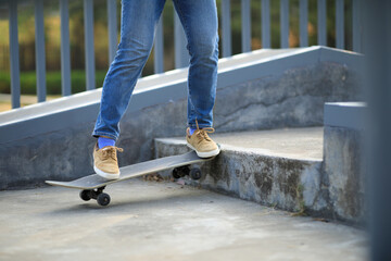 Asian woman skateboarder skateboarding at skatepark