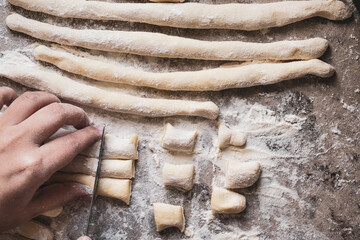 cut dough rolls to make gnocchi