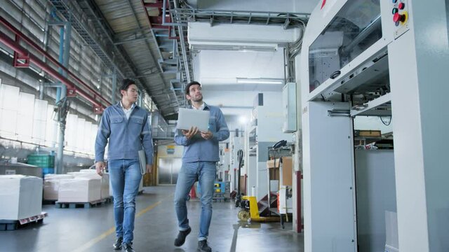 specialist worker engineer team control and operate printing package lable machine with computer screen with concentrate and focus industrial factory machinery ideas concept