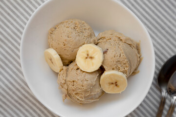 Homemade Peanut Butter Banana Ice Cream in a Bowl, top view. Flat lay, overhead, from above. Close-up.