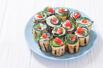 Zucchini rolls with cream cheese , tomatoes and dill