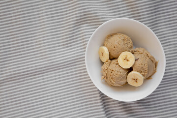Homemade Peanut Butter Banana Ice Cream in a Bowl, top view. Flat lay, overhead, from above. Copy space.