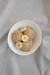 Homemade Peanut Butter Banana Ice Cream in a Bowl, top view. Flat lay, overhead, from above.