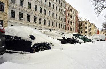 Snow covered cars parked in winter season on the street