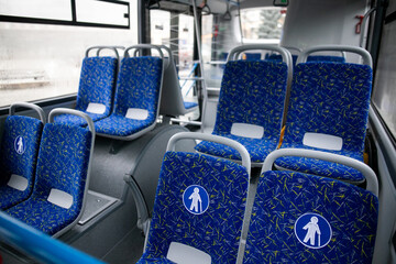Empty bus interior. Blue seats without passengers. Public transport. Transportation of passengers by public transport. Ergonomic interior of the bus. Travel to other cities.