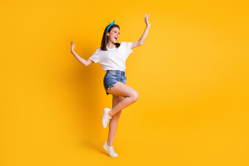 Fototapeta na wymiar Full length body size view of slender lovely cheerful brown-haired girl jumping dancing isolated over bright yellow color background