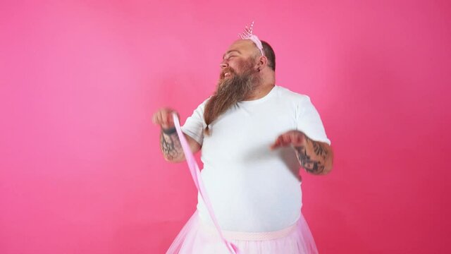 Funny man dancing and having fun while wearing a ballerina costume