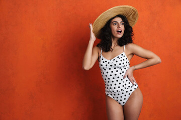 Joyful beautiful woman in swimsuit smiling while posing on camera