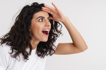 Excited brunette girl expressing surprise and looking aside