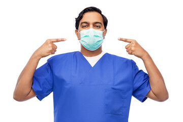 Fototapeta na wymiar healthcare, profession and medicine concept - indian doctor or male nurse in blue uniform showing protective medical mask for protection from virus disease on his face over white background