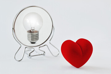 Heart looking in the mirror and seeing itself as a light bulb - Concept of dualism heart/mind,...
