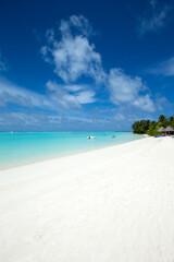 tropical Maldives island with white sandy beach and sea