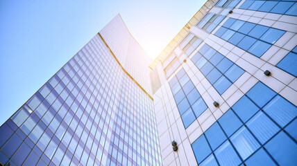 Fototapeta na wymiar Downtown corporate business district architecture. Glass reflective office buildings against blue sky and sun light. Economy, finances, business activity concept.