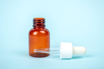 Cosmetic bottle isolated on blue background. Mock up container for design. Medical and cosmetics concept.