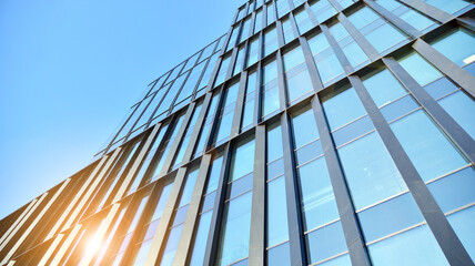 Downtown corporate business district architecture. Glass reflective office buildings against blue sky and sun light. Economy, finances, business activity concept.