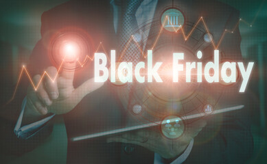 A businessman operating a computer display with a Black Friday business word concept on it.
