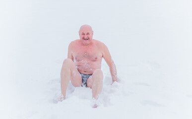 Senior man 50 - 60+ on a snow , Improvement and strengthening of the immune system, health improvement procedures