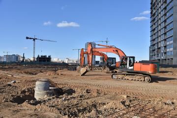 Excavator on earthworks at construction site. Backhoe on foundation work and road construction....