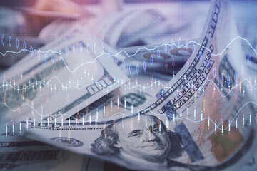 Double exposure of forex graph drawing over us dollars bill background. Concept of financial markets.