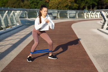 Fitness model working out with expander