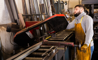 Portrait of professional man worker during work in workshop
