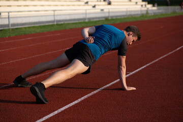 Athletic enduring man doing exercises