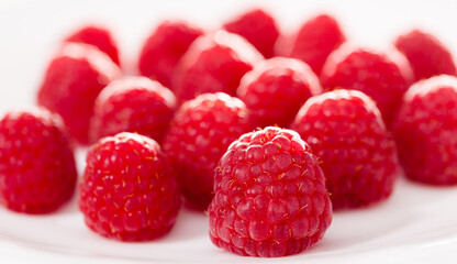 handful of raspberry berries on white background