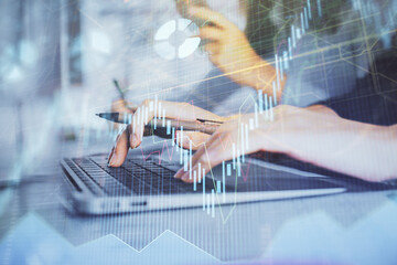 Multi exposure of woman hands typing on computer and financial graph hologram drawing. Stock market analysis concept.