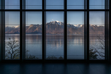 View of snow-capped mountains across Lake Geneva.