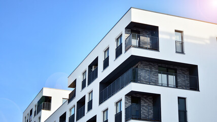 Modern apartment buildings on a sunny day with a blue sky. Facade of a modern apartment building.Glass surface with sunlight.