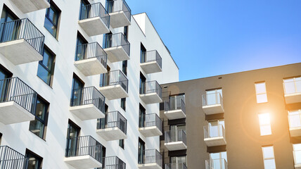 Modern apartment buildings on a sunny day with a blue sky. Facade of a modern apartment building.Glass surface with sunlight.
