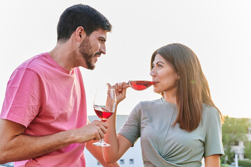 portrait of young couple having a glass of wine at sunset