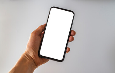 Woman hand holds smartphone with white screen. Female hand demonstrating new smartphone with blank screen